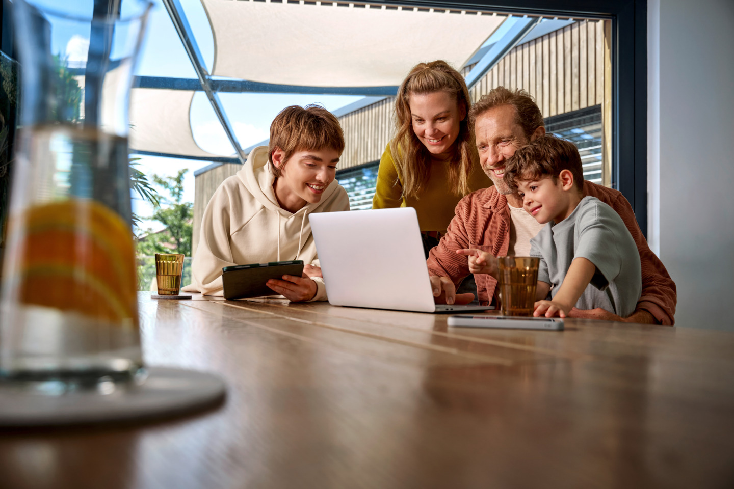 Four people looking at a laptop